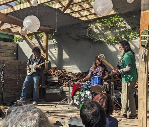 Drew Gardner Band in action, trio of guitar bass drums