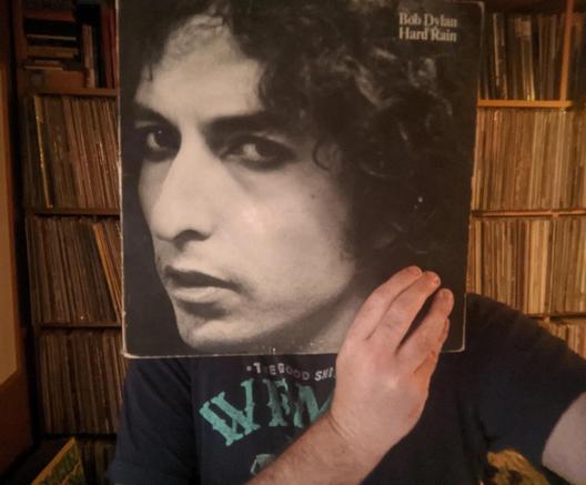 your DJ, holding "Desire" LP in front of face