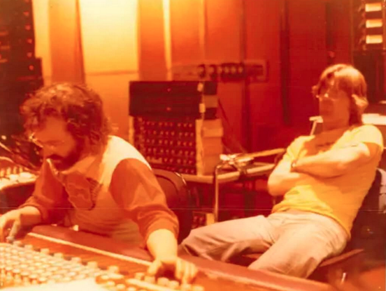 Owsley Stanley at mixing console, Phil Lesh looks on with resting surly face
