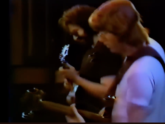 Jerry Garcia and Phil Lesh jam, shot from sidestage