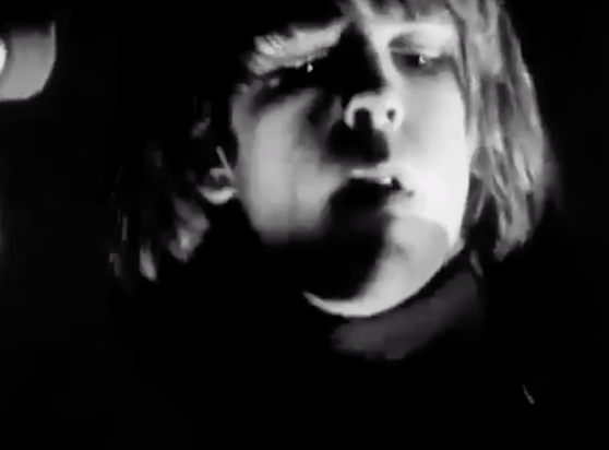 Bobby Weir, in black and white, looking like he's ready to be hauled back to middle school