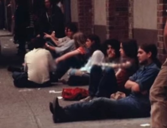 people hanging outside the Beacon, sitting on sidewalk