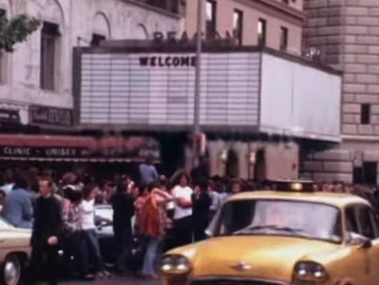 empty marquee at Beacon Theatre plus street scene & yellow cab