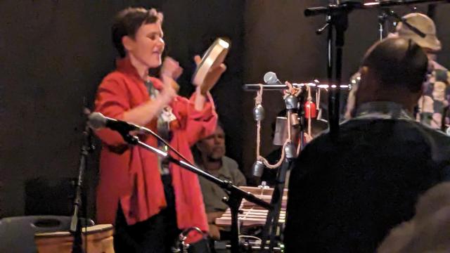 Bex Burch plays percussion 