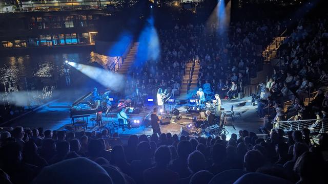 Anne Waldman and Laurie Anderson sing Ballad of the Skeletons in an amphitheater overlooking the water 