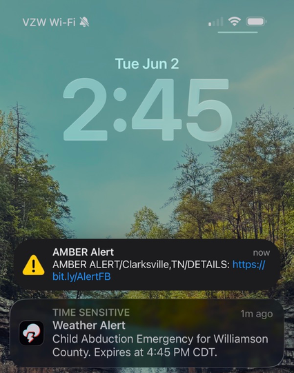 An iPhone lock screen on Tuesday, June 2 at 2:45, showing two stacked notifications: an 'AMBER Alert' for Clarksville, TN with a bit.ly link to details, and a 'Time Sensitive' Weather Alert reading 'Child Abduction Emergency for Williamson County. Expires at 4:45 PM CDT.'