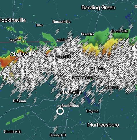 Weather radar map of Tennessee showing thunderstorms with lightning symbols concentrated across the central region including Nashville, Springfield, and Gallatin, with lighter precipitation to the north and west.