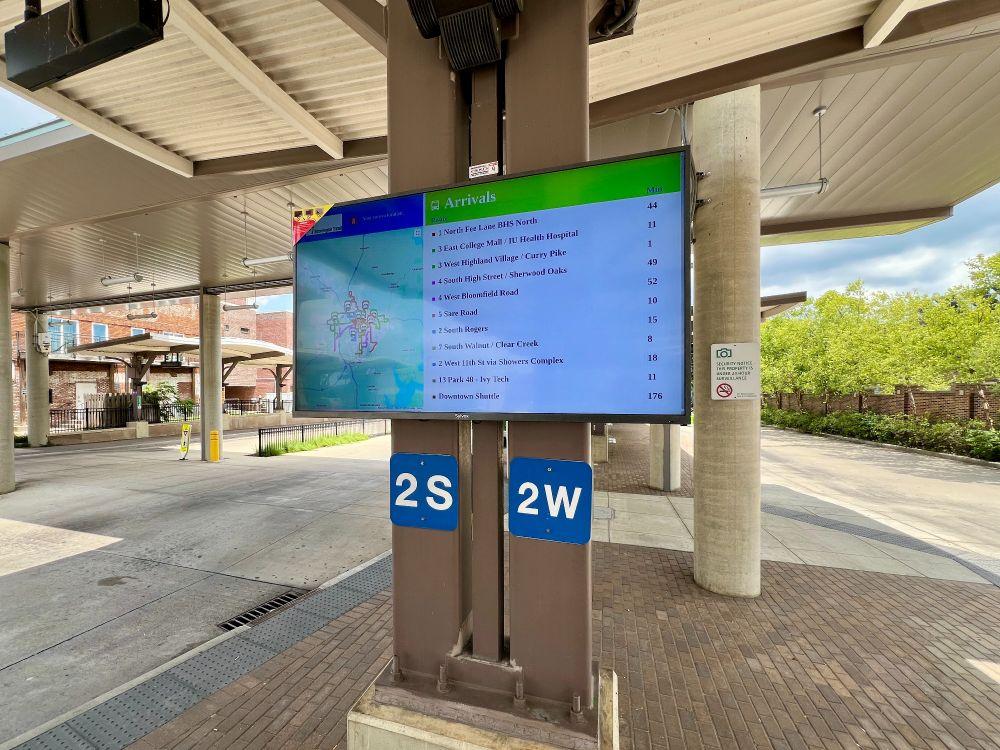 An outdoor bus tracking monitor at the Bloomington Transit Station