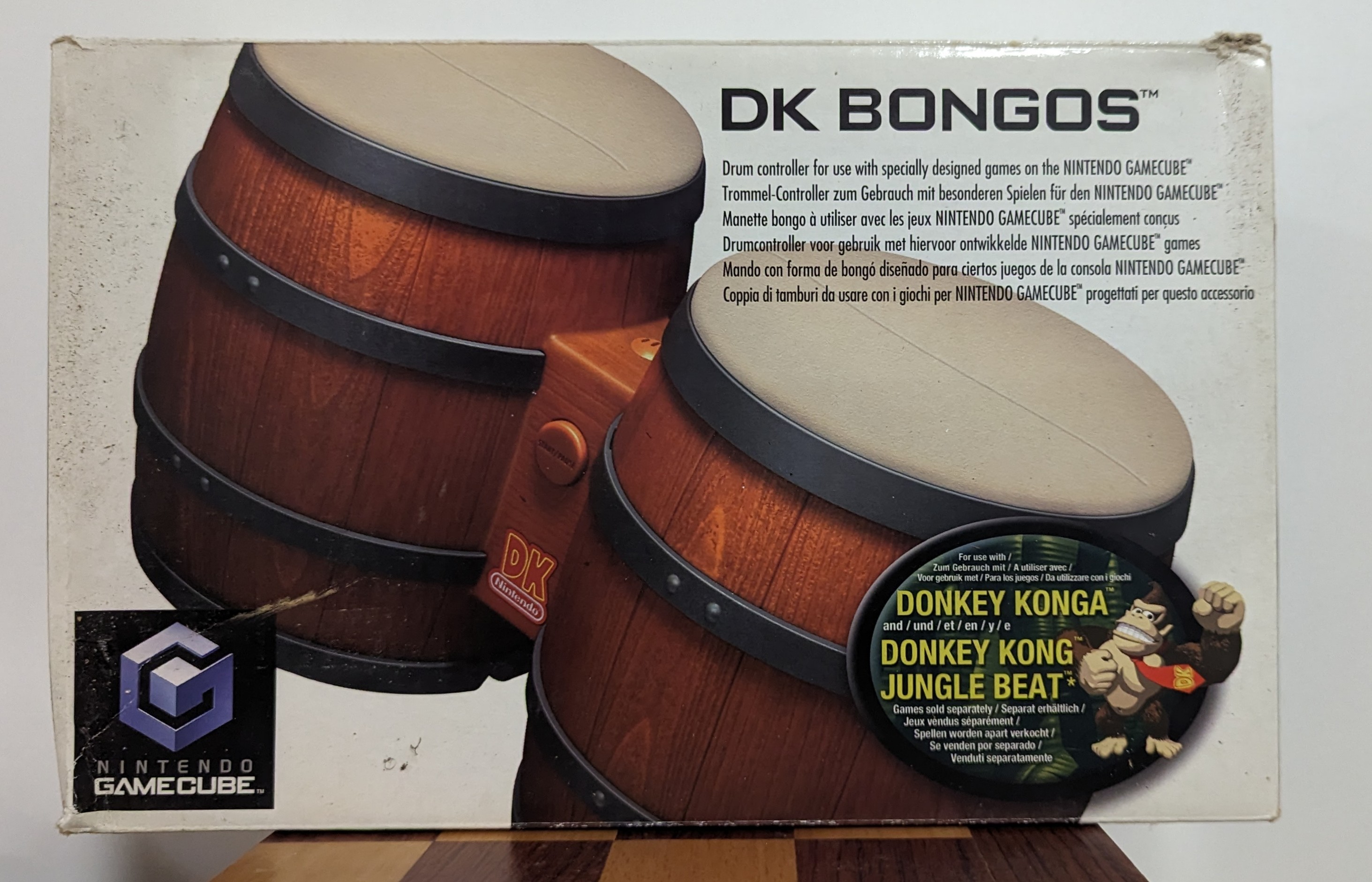 The box for DK (Donkey Kong) Bongos that connected to the Nintendo GameCube. The bongos are recognised controllers for the Donkey Konga and Donkey Kong Jungle Beat games for the Nintendo GameCube.