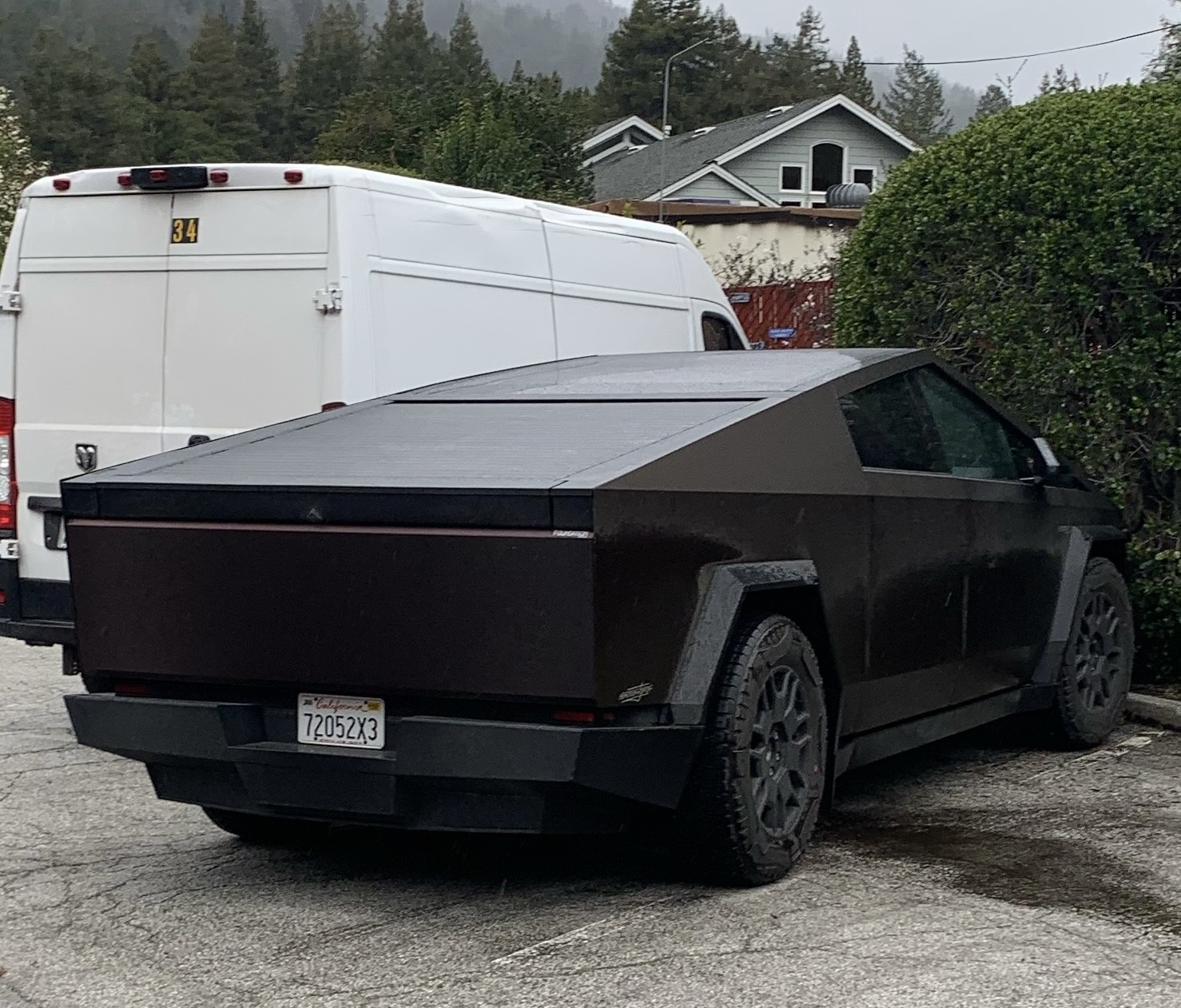 A Tesla Cyber Truck custom painted in a dark brown.  