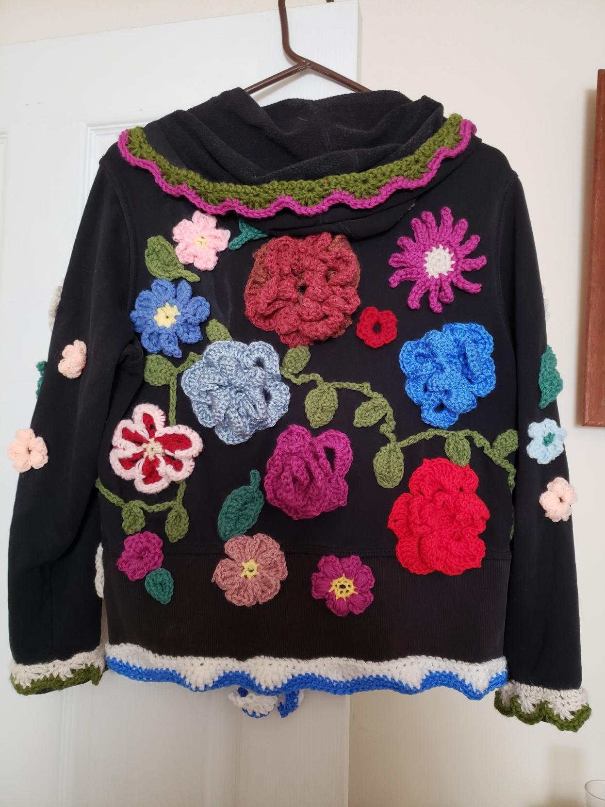 The back of the same hoodie with more flowers, etc