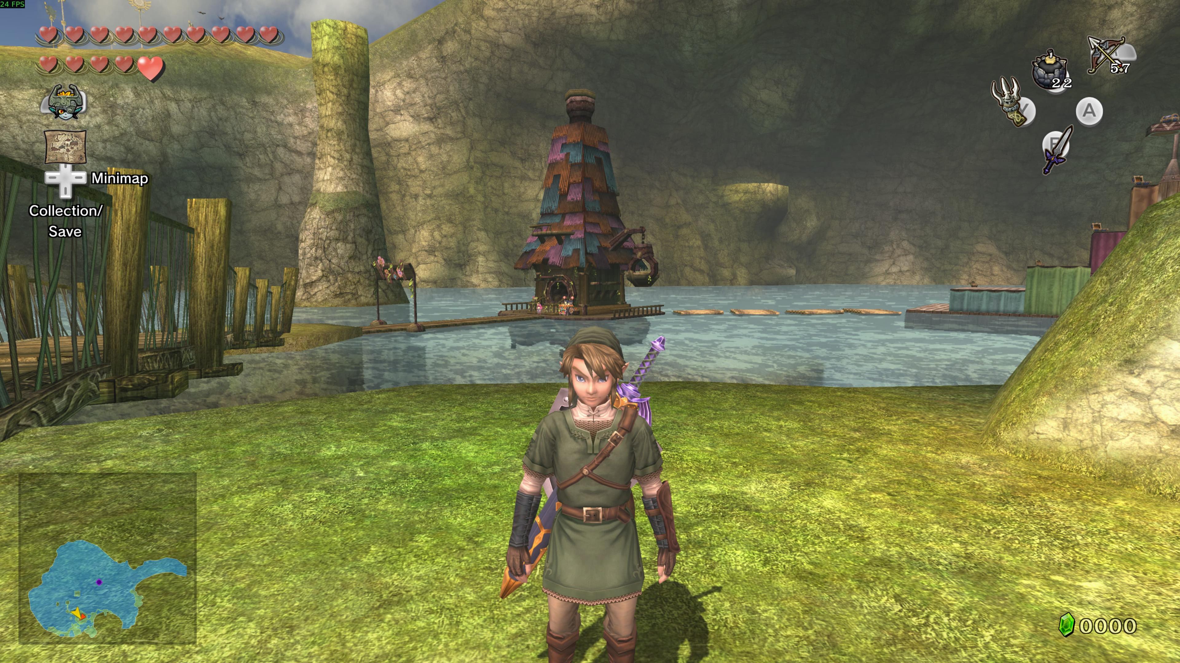 A screenshot from the game The Legend of Zelda Twilight Princess. Link is facing the screen. In the background is Lake Hylia and a house with a cannon built into it. Link is standing on grass. In the background cliffs are rising up to the sky.