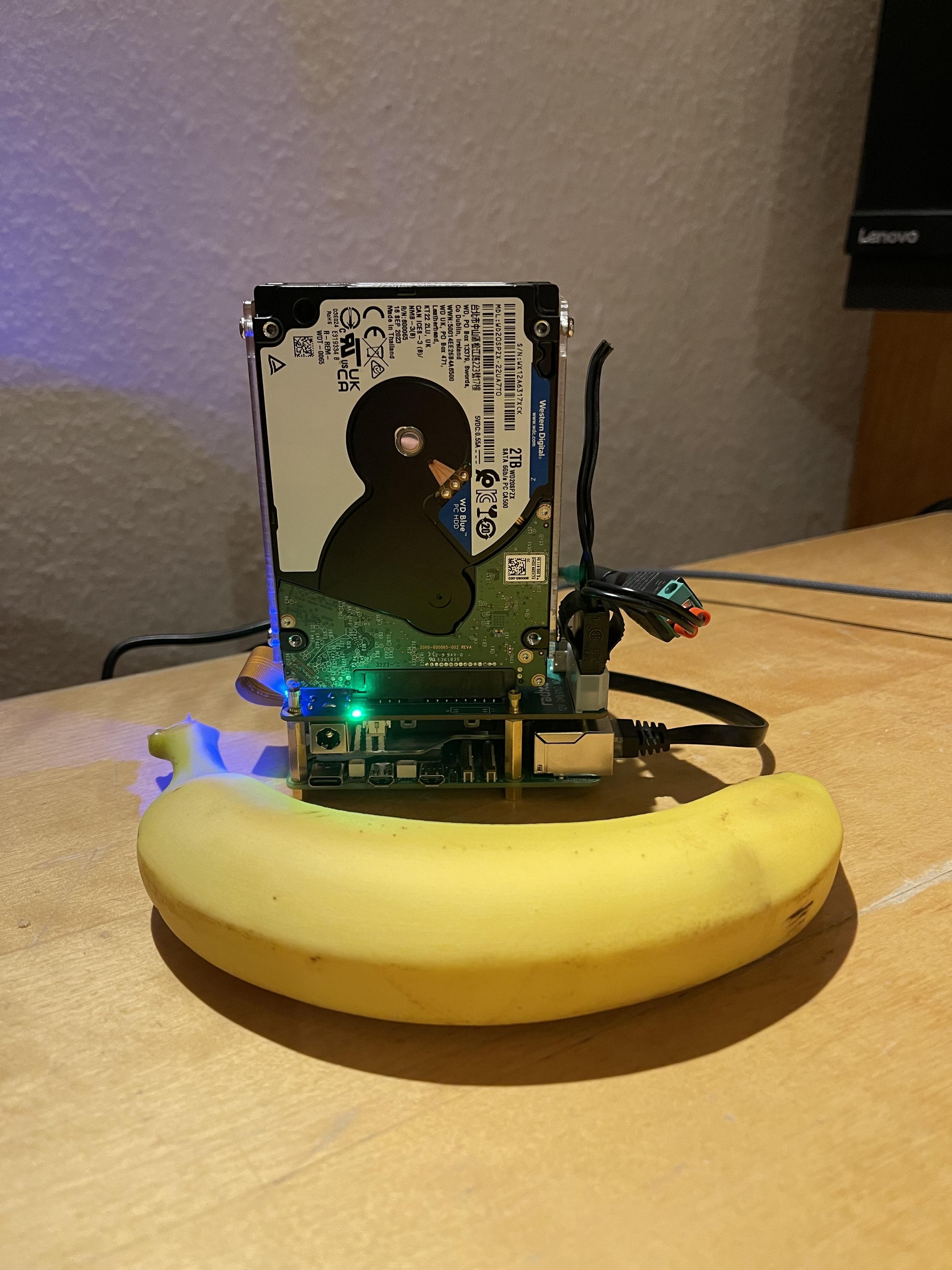 A 2.5 inch hard drive with a computer attached to it. Banana for scale. (The computer is smaller).