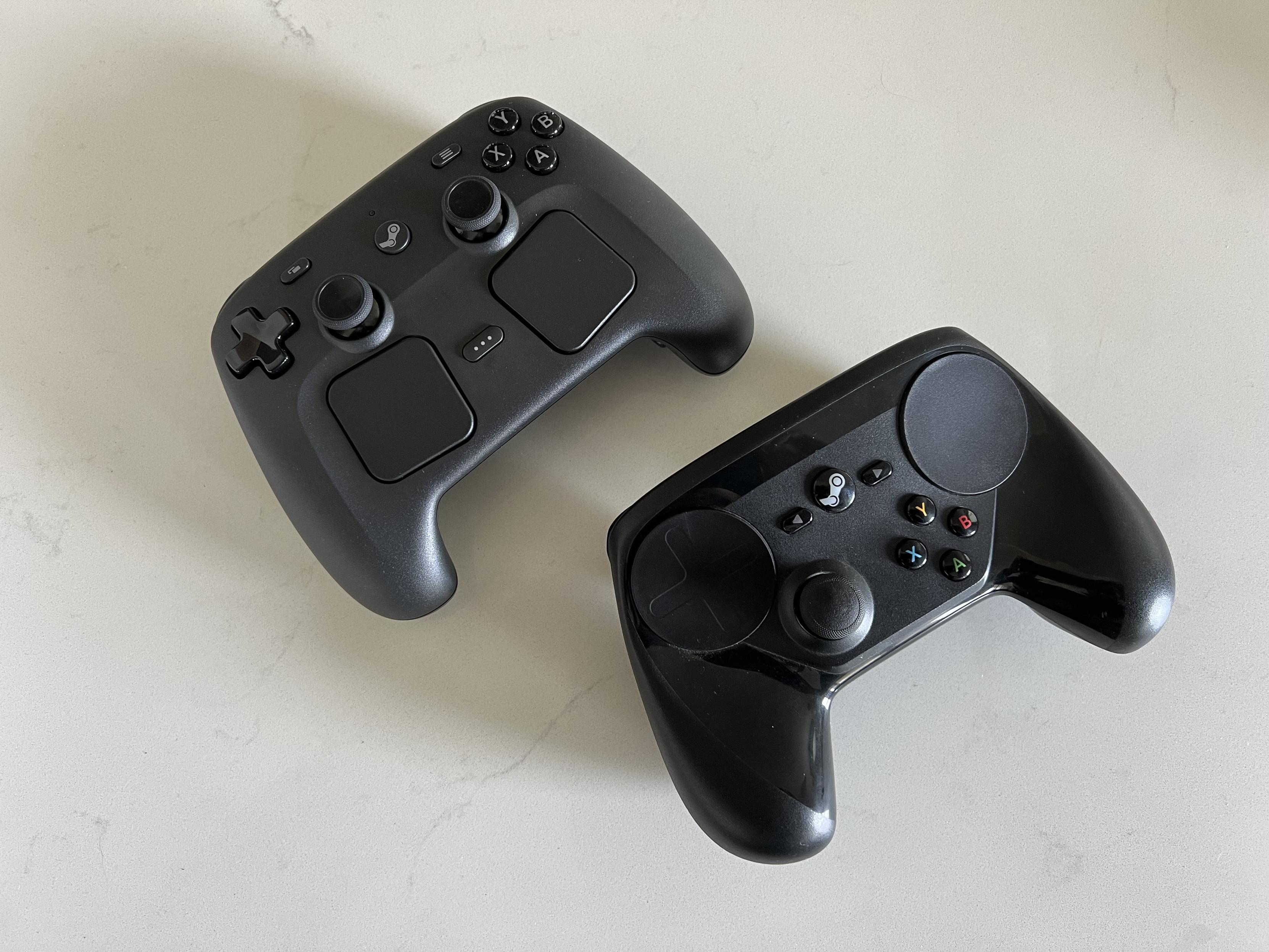 The original steam controller next to the new one sitting on a white countertop