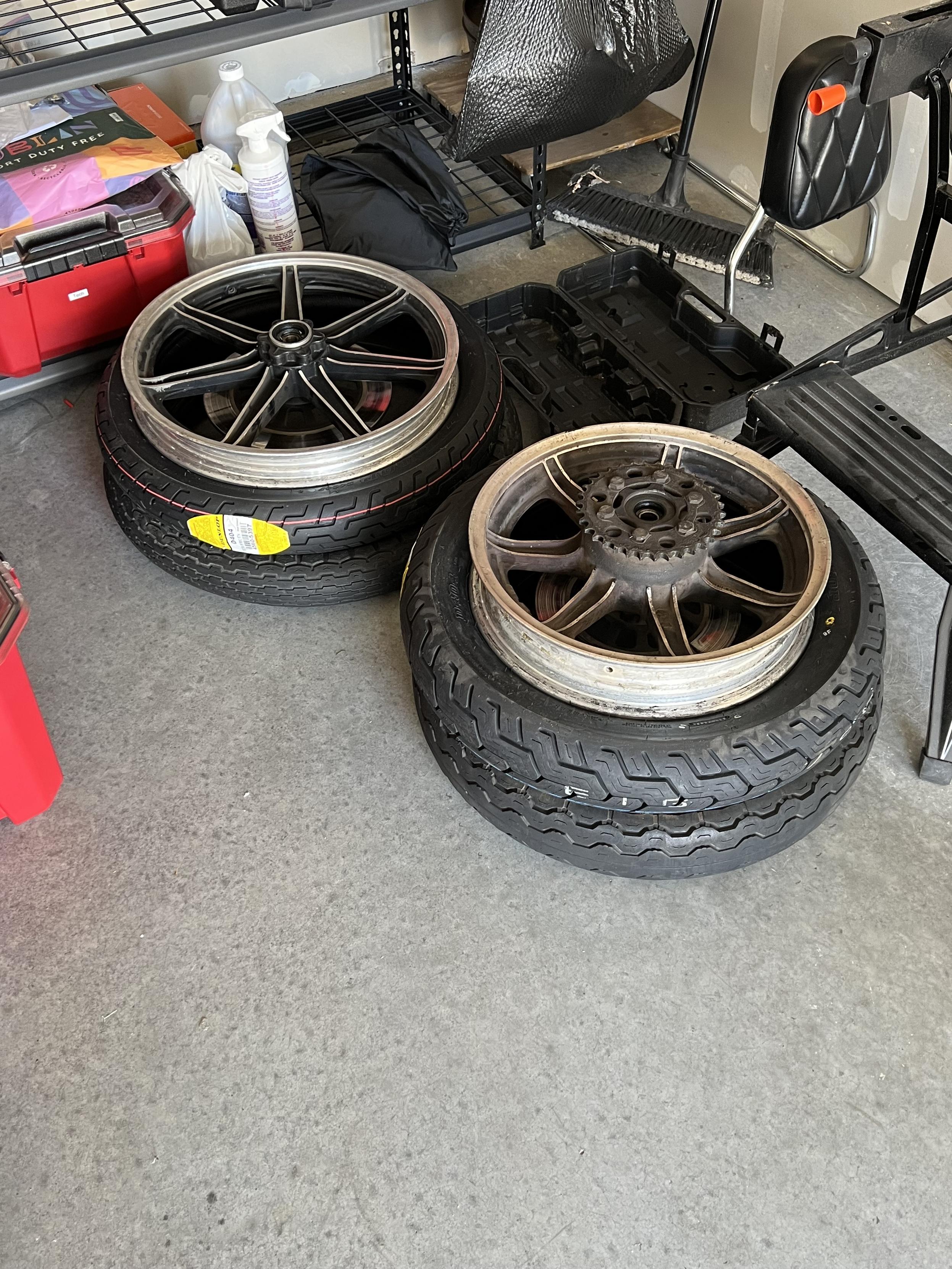 Motorcycle wheels stacked on both the old tyres and new tires