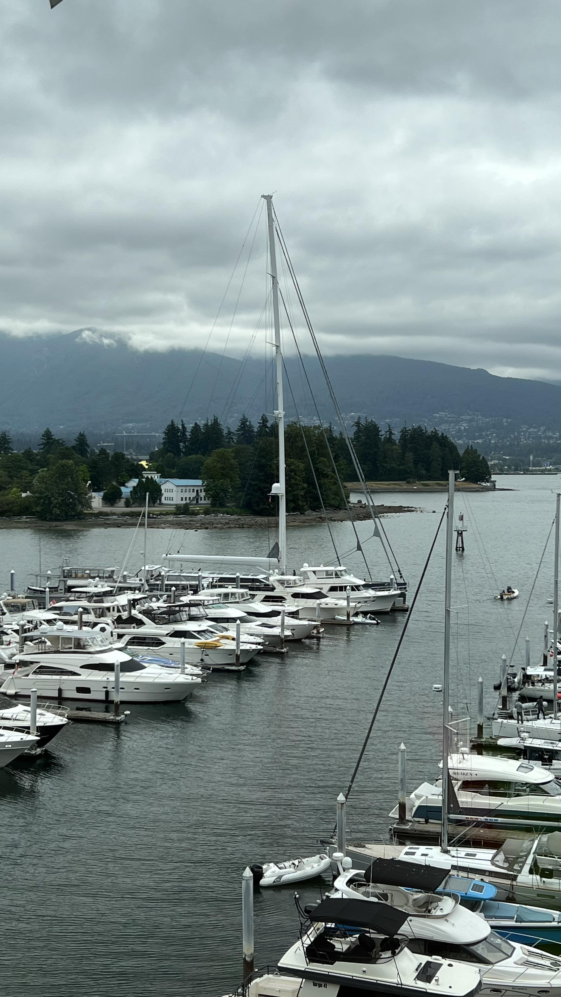 The mast of a big sailboat docked in the harbour