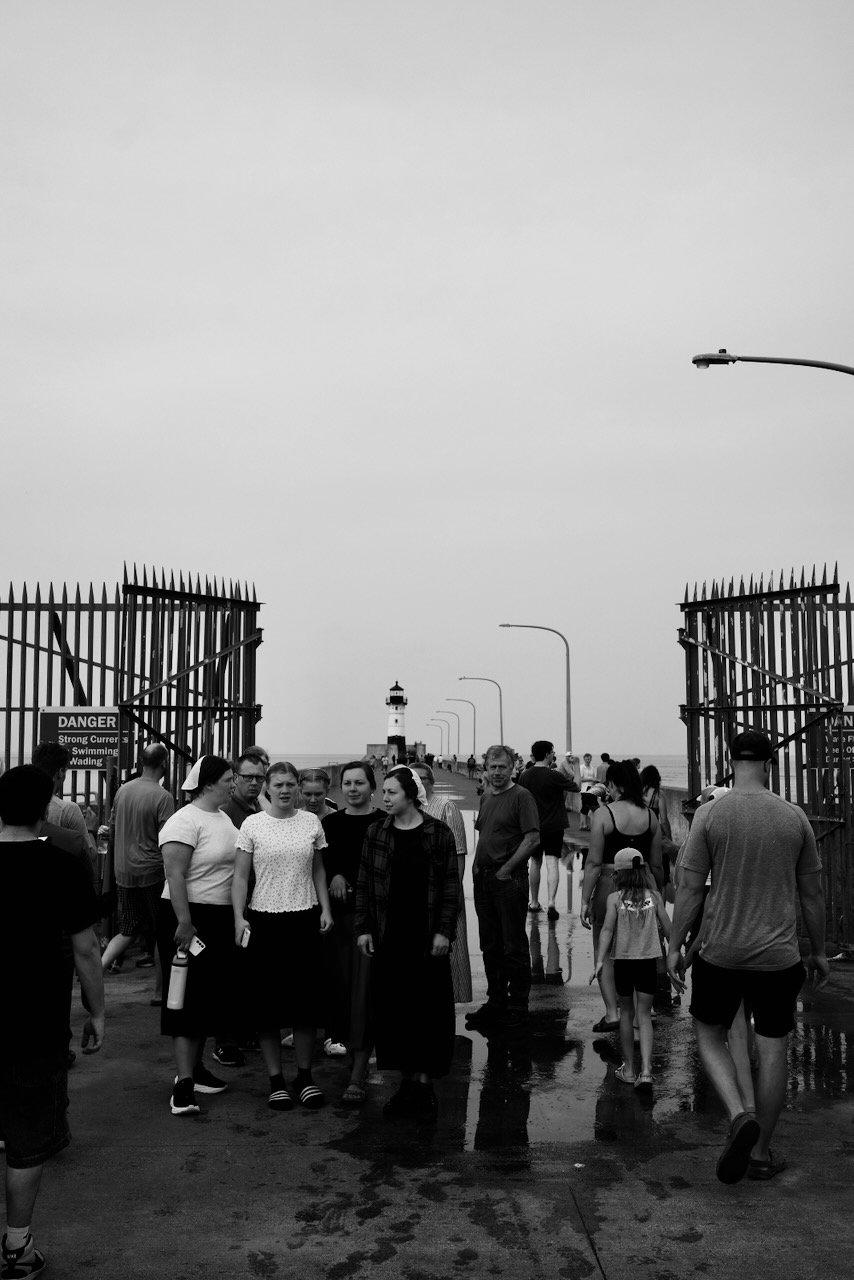 Crowd of people walking to the lighthouse - Canal Park - Duluth