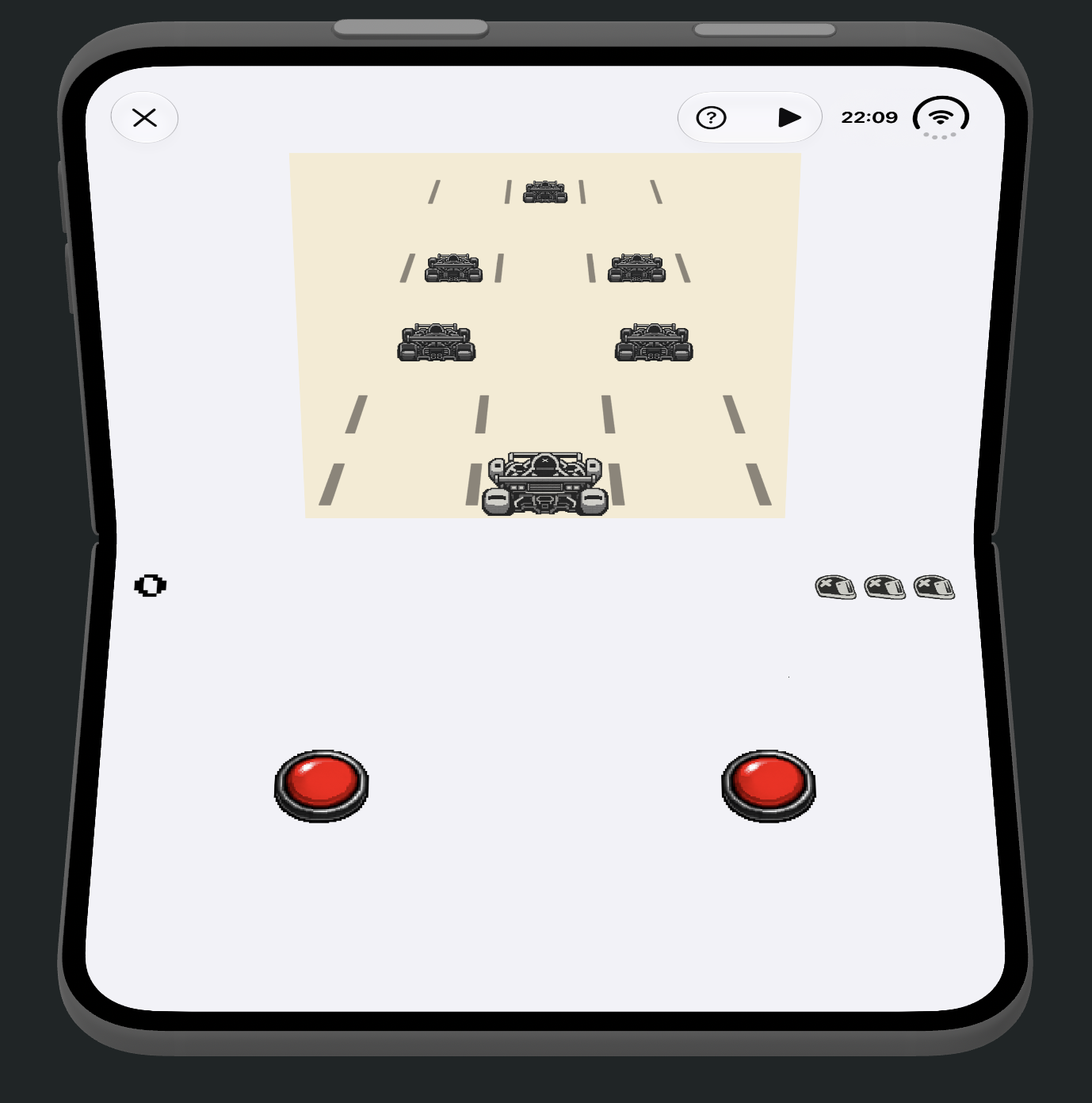 A folding phone shown open at roughly a right angle, styled like a handheld game console. The top half displays RetroRapid! in arcade mode: a car dodging three lanes of oncoming traffic, with three lives shown as small car icons in the top right. The bottom half of the folded device serves as a controller, with a red button on each side for steering left and right.