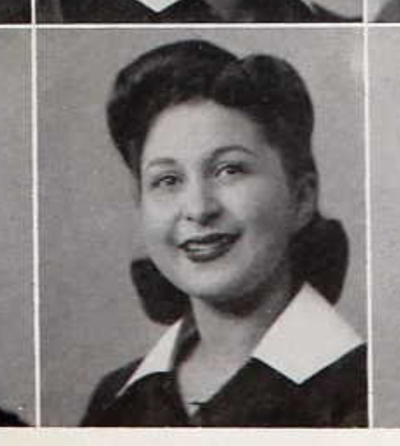 black and white portrait of a smiling young woman from the 1940s