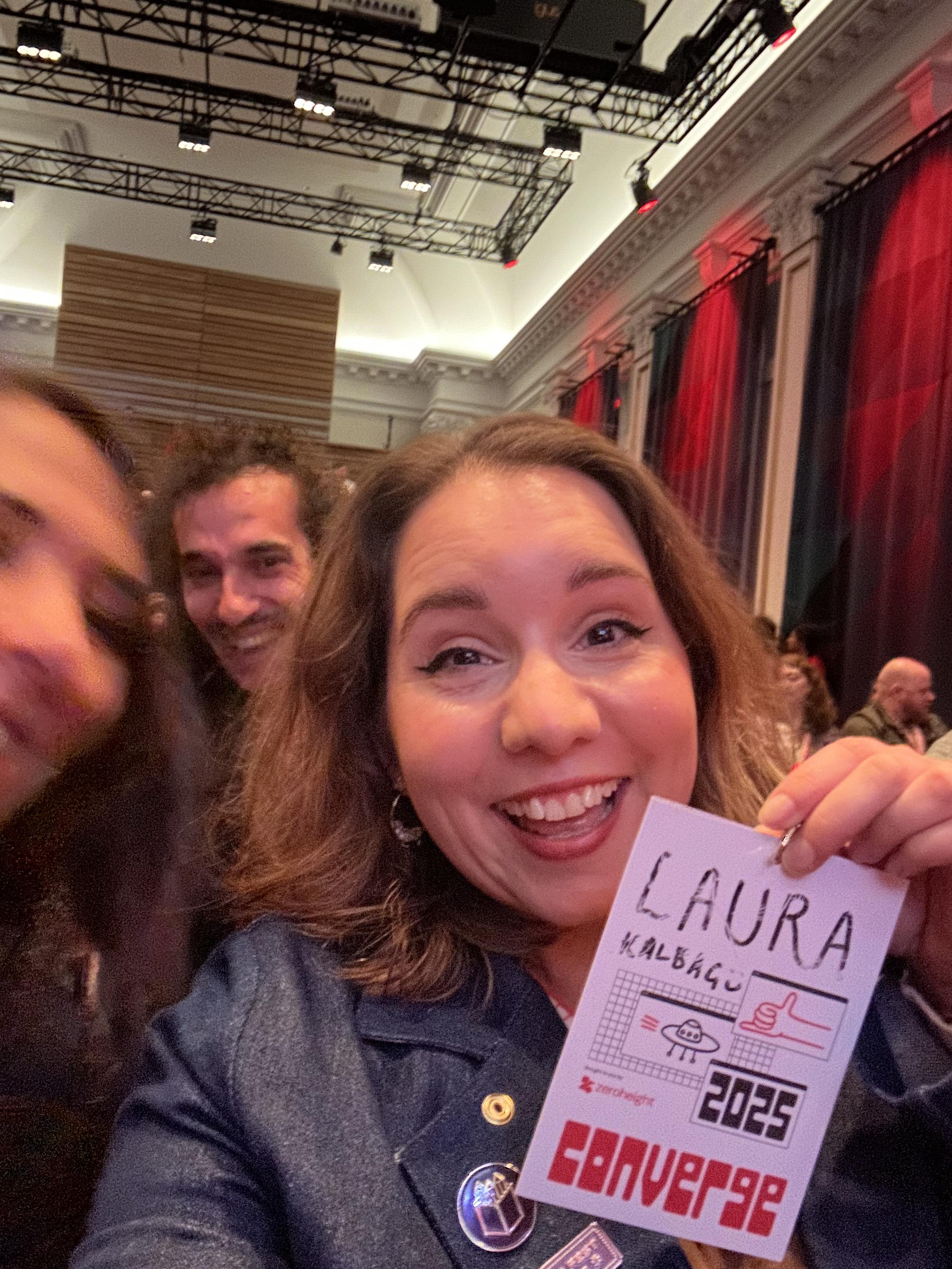 Me with my conference badge, my name is in pen and is being rubbed out.  Natalya and Ismaïl are peering over my shoulder.