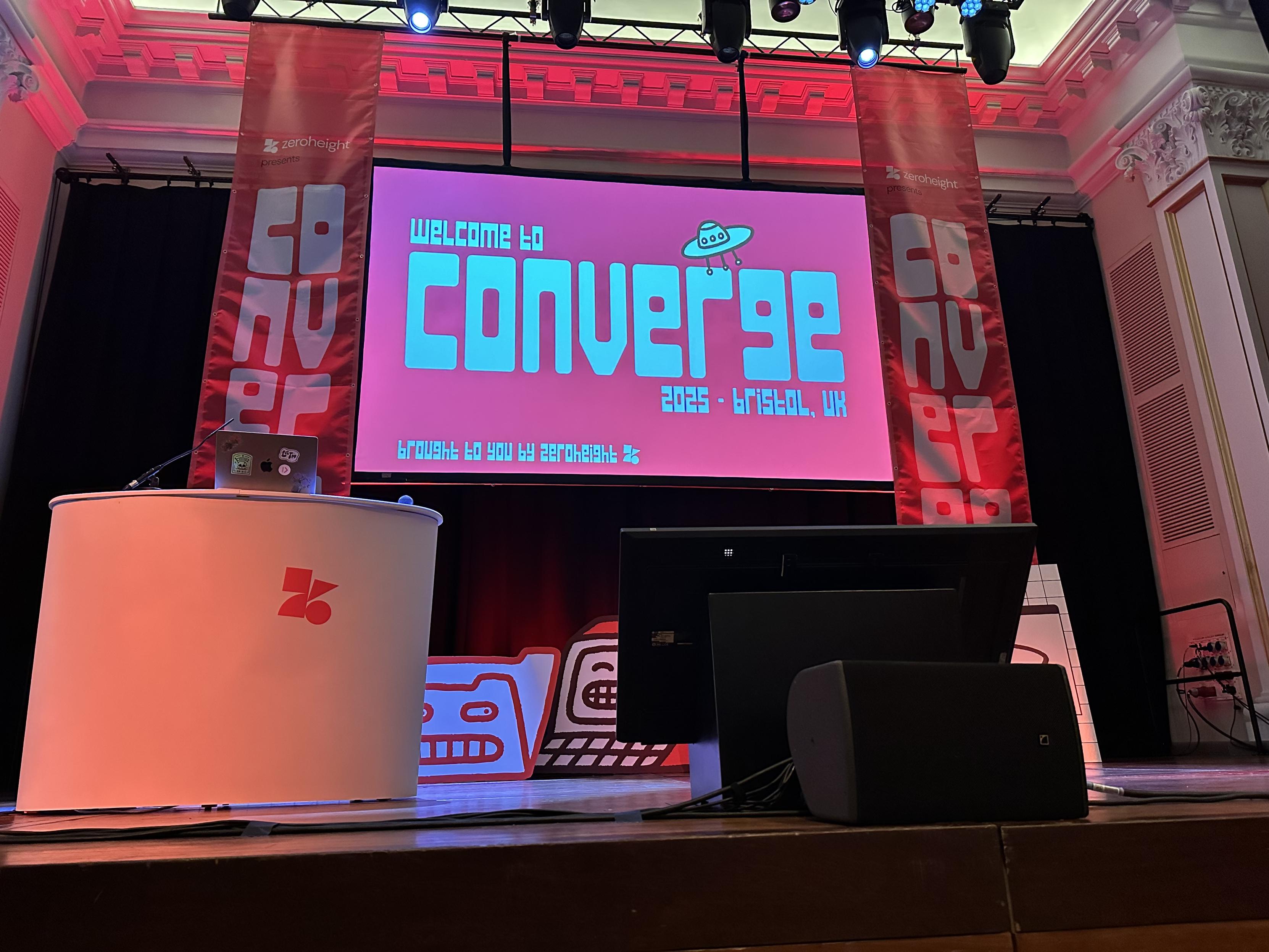 Slide on a stage saying Welcome to Converge 2025, Bristol UK.