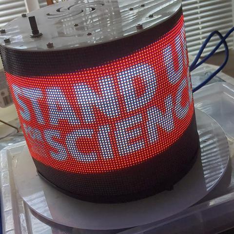 LED display wrapped around a top hat bearing a logo for the mad scientist meetup.