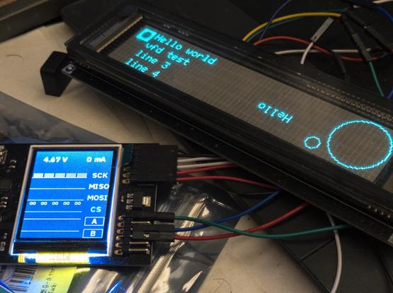 vacuum florescent display showing "hello world test" connected to an SPIDriver