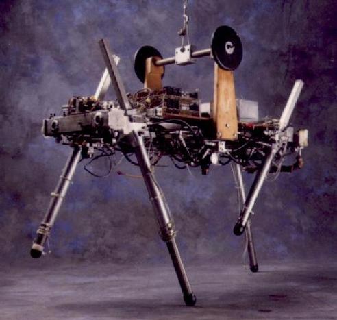 An early quadruped robot with pneumatic legs from the late 80s, held by a chain above
