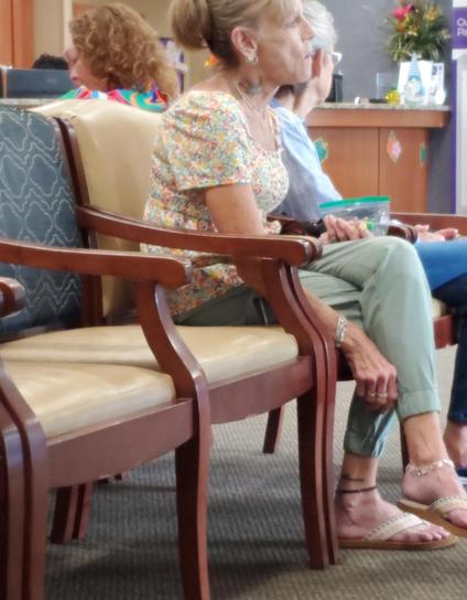 woman in her 60s or 70s with an bird (maybe eagle) tattooed on her neck