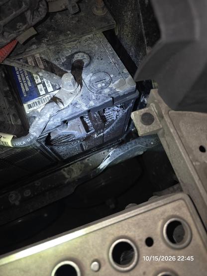 Photograph of a truck's battery. The entire side is missing and the diodes are visible inside
