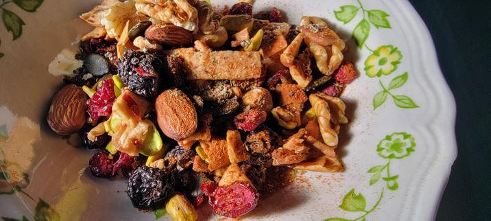 MIx of almonds, raisins, cranberries, pumpkin seed, pistachio, dried apple, sprinkled with salt, black pepper, cayenne, oregano, sage.