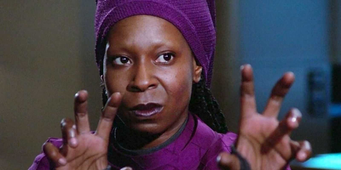 Quinan, her hands raised like claws, glaring at Q