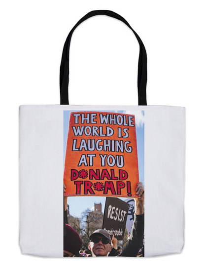 Tote bag with an anti-Trump protestor in Washington Square Park in New York City holds a sign that says, "The Whole World is Laughing at You, Donald Trump," while other signs say, "Resist," and legendary Representative John Lewis's admonition to start #goodtrouble in the fight for democracy.