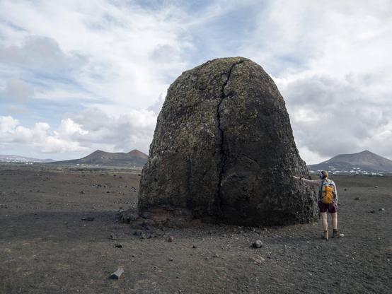 Huge Volcanic bomb with tiny human for scale