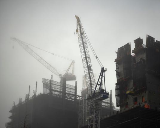 The giant cranes and buildings are slowly consumed by the fog rolling in off of the Hudson.