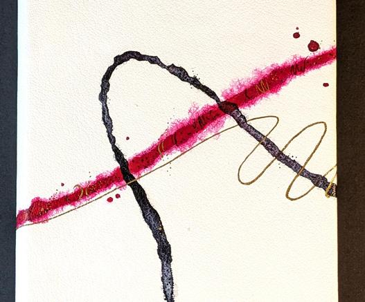 A close up of a book cover showing the detail of red, black, and gold painted lines.