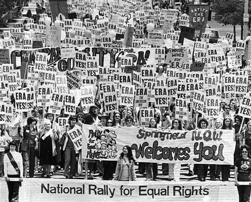 Huge ERA march, with wall to wall people carrying signs that read: ERA YES! and other related messages. In the front, a banner that reads: Springfield N.O.W. welcomes you.