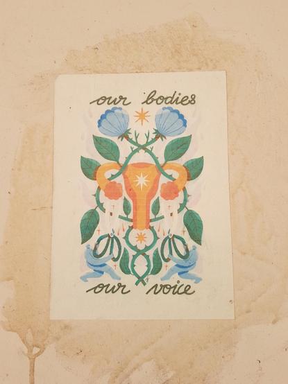 Collage on which is written: "our bodies our voice". In the centre one can see a drawing of an uterus decorated by flowers.