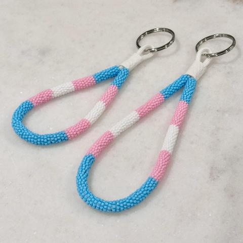 Two bead wrapped keychains in the trans pride colors--one regular sized and one mini