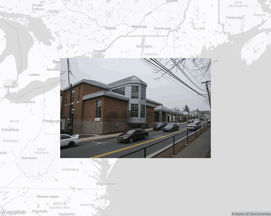 A photo of or from a library from the linked website, overlaid on a cropped world map where it's located.