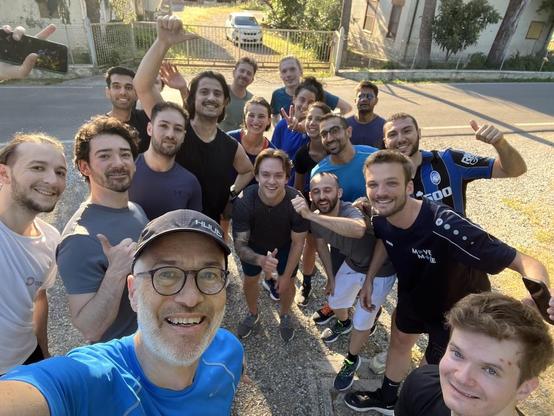 Selfie of the ISWS 2024 running group, Day 01, at the point of return back up hill to the castle...