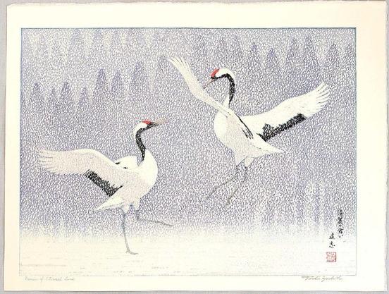Two cranes dancing in heavy snowfall