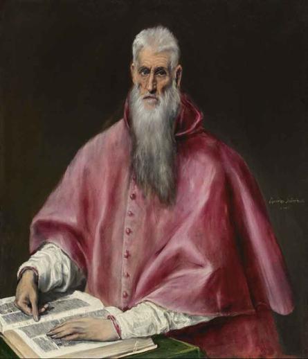 An old man, long white beard, seated at a table, his hands on a book.