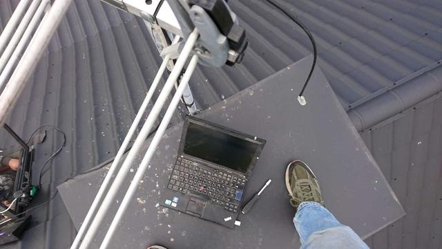Looking downwards on a chimney – there's a leg of the person holding the camera, and old laptop, TV antennas go diagonally across the image.