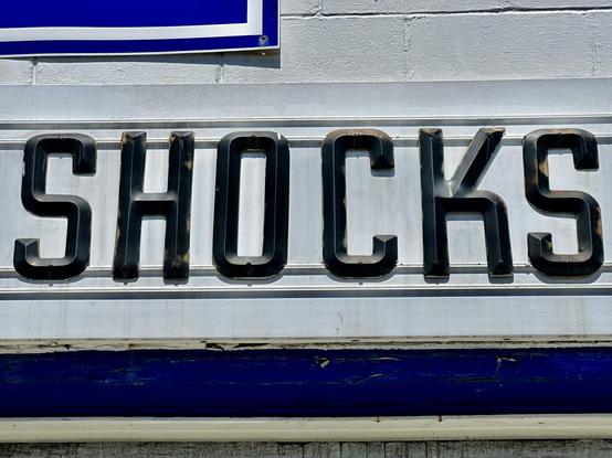 Plastic sans-serif letters spelling out “shocks”.
