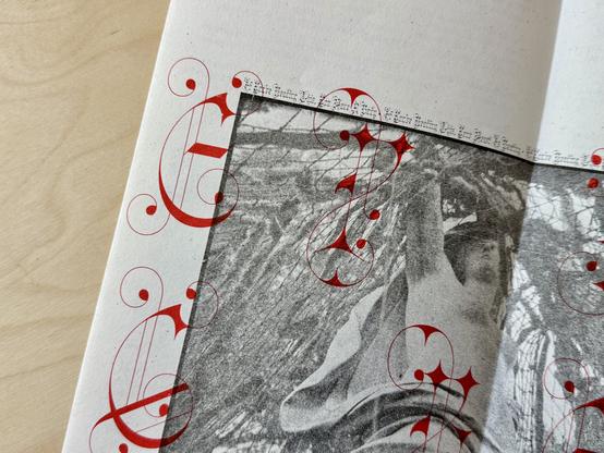 Closeup of the cover page of Robin Sloan’s zine, ‘The Secret Playbook’. A highly textured Risograph print of a greyscale photo, with ornate, condensed blackletter caps (Clavichord, from DJR) overlaid in red ink.