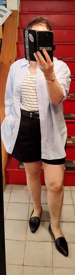 Black shorts (almost Bermudas but not quite), striped T, crisp oversized blue button up layered over all. Black belt, black loafers, blue Greek island beads. Bangle bracelets.