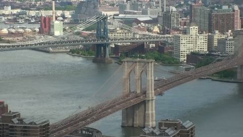 This webcam usually shows the New York city skyline with skyscrapers and the Brooklyn Bridge and the Manhattan Bridge in the center of the view. It's a cloudy day. It's 68ºF/20ºC.