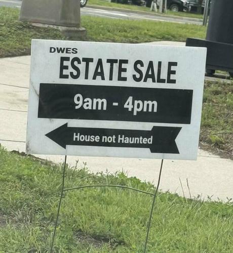Estate sale sign.."House Not Haunted" in text underneath