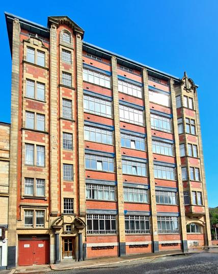 A 1920s brick and stone commercial building in Glasgow.